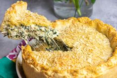 a close up of a pie on a plate with a spatula in it's hand