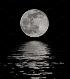 the full moon is reflected in the water