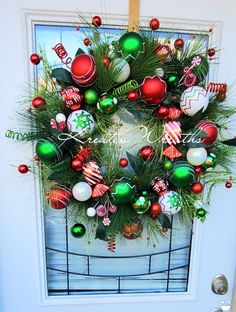 a christmas wreath is hanging on the front door