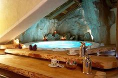 an indoor hot tub with candles on the counter