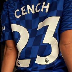 the back of a soccer player's blue and white shirt with numbers on it