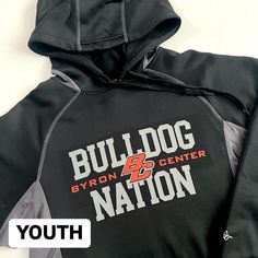 YOUTH black and grey Bulldog Nation hoodie Alleson Brand. "Gameday" sweatshirt with grey stitching and accents. Pullover style. Relaxed fit. Front pockets. Youth does not have drawstring in hood. Youth sizing. RUNS BIG. No restock. Washing inside out is preferred. -------- REQUIRES LOCAL PICKUP at my residence (will message my address).  There are shipping upgrades available if you would like me to drop off your order within Byron Center or ship it within the United States. RETURN POLICY Unwashed and unworn items in excellent condition can be exchanged for a different size if available or I am happy to offer store credit toward a future purchase. In the rare event that a design element comes off or you have a problem with the quality of the piece, you can bring it back to me to repair with Grey Bulldog, Gameday Sweatshirt, Bring It Back, Drop Off, Design Element, Pullover Styling, Clothing Items, 1 Year, Bulldog