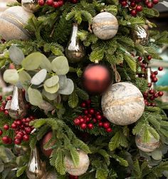 a christmas tree decorated with ornaments and greenery