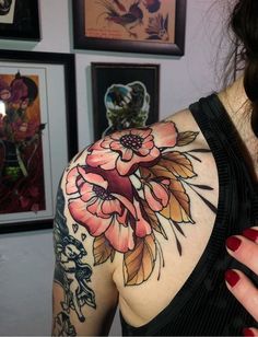 a woman's shoulder with flowers on it