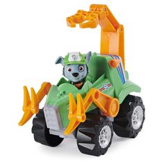 a green and orange toy truck with a dog on it's front wheel, in front of a white background