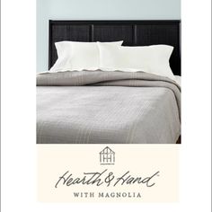 a bed with white sheets and pillows in a bedroom next to the words north & hand with magnolia