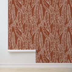 an orange and white wallpaper with leaves on it