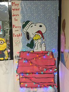 a door decorated to look like a house with a snoopy christmas decoration on it