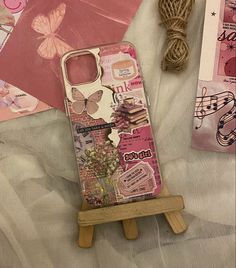 a cell phone case sitting on top of a wooden easel