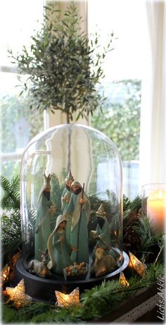 a glass dome filled with figurines on top of a table