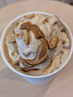 a white bowl filled with ice cream and nuts