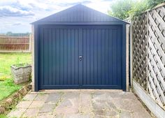 an outdoor storage shed in the middle of a yard with a brick walkway leading to it