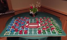 a football themed table with cups and vases on it