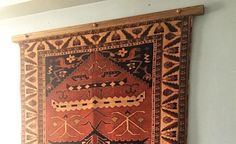 an old rug hanging on the wall