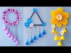 three different types of paper flowers hanging on the wall