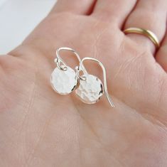 I've applied a hammered finish to 9mm discs and hung them from simple, classic ear wires. Perfect everyday earrings! ~available in sterling silver, 14K gold-filled or Rose gold filled, all considered safe for sensitive ears ~9mm hand hammered discs >>To enter to my shop<< http://www.kgarnerdesigns.etsy.com Please contact me PRIOR TO PURCHASE if you are ordering on a deadline. I can usually accommodate quick shipping if I am made aware of your deadline. Expedited shipping is available Simple Silver Hammered Earrings, Simple Hammered Silver Earrings, Dainty Sterling Silver Hammered Earrings, Dainty Hammered Sterling Silver Earrings, Everyday Earrings Simple, Small Dangle Earrings, Earrings Everyday, Gold Disc, Earrings Simple