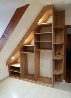 an attic bedroom with built in shelving units