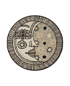 a round rug with an image of the moon and stars on it's side