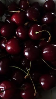 a bunch of cherries sitting on top of each other