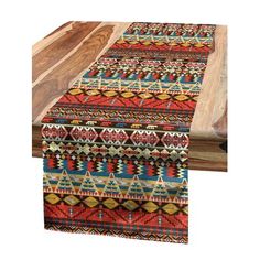 the table runner is made from wood and has colorful designs on it