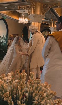 the bride and groom are getting ready to walk down the aisle