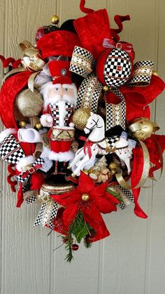 a christmas wreath with santa claus and other ornaments hanging from the front door ornament