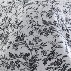 black and white bedding with flowers on it