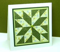 a card with a green and white quilted design on the front, sitting on top of a table