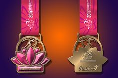 two gold medals with pink ribbons around them on a purple and orange background, one has a lotus symbol