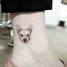 a small dog's head on the ankle is shown in black and grey ink