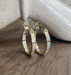 The perfect hoops for everyone, everyday, all day! These comfortable little beauties will take you from day to night and look great dressed down but fit in to formal events with ease. Super fiery opals are inlaid into these darling little 14k gold plated classic hoops. Hoops measure 20 mm and are 3mm thick. In inches these are about 3/4" hoops.*Perfect for bridesmaids*These arrive ready for gifting in a cute, boho gift box Elegant Opal Hoop Earrings, Elegant Gold Opal Hoop Earrings, Gold Opal Small Hoop Earrings, Small Gold Hoop Earrings With Opal, Elegant Opal Huggie Earrings, Elegant Opal Huggie Jewelry, White 14k Gold Small Hoop Huggie Earrings, Opal Stud Earrings, Opal Earrings Stud