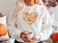 "Fall Heart Doodles 🎃🧡 Celebrate your love of Fall and Pumpkins with one of our trendy tees or sweatshirts! You'll love this cute pumpkin shirt so much, that you'll want to wear it all year! Shop MORE FALL Shirts/Sweatshirts here: https://etsy.me/2XrN5hB * * * * * * * * * * * * * * * * * * * * * * * * * * * * * ♥️ LISTING 1 - Fall Heart Doodles Shirt or Sweatshirt HOW TO ORDER: * Choose size. (Unisex T-Shirt or Crewneck Sweatshirt) * Select Color if available. * Enter personalization if needed Doodle Shirt, Heart Sweatshirt, Heart Sweater, Pumpkin Shirt, Heart Shirt, Trendy Tee, Fall Sweatshirt, Love Shirt, Look Plus