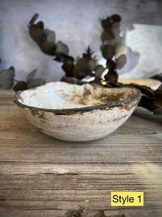 a white bowl sitting on top of a wooden table