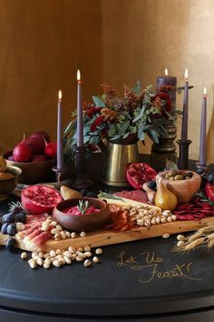 a table topped with lots of food and candles