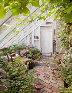 an old greenhouse is filled with potted plants