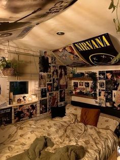 a bed room with a bunch of pictures on the wall and a tv in the corner