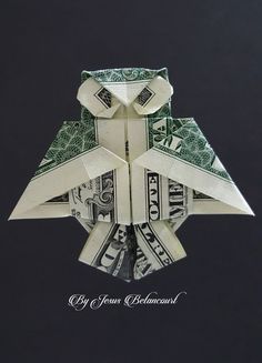 an origami owl made out of dollar bills on a black background with the words,