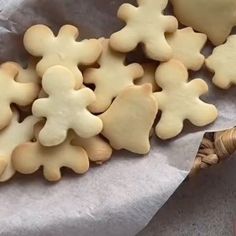 some cut out cookies sitting on top of a piece of paper next to a basket