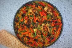 a pan filled with rice and vegetables on top of a counter