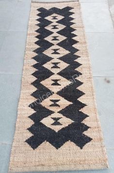 an old black and white rug on the ground with no one in it or someone standing next to it