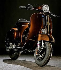 a brown motor scooter parked in the dark