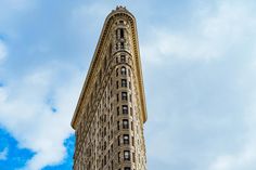 the top of a tall building against a cloudy blue sky