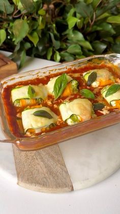 a casserole dish filled with vegetables and sauce