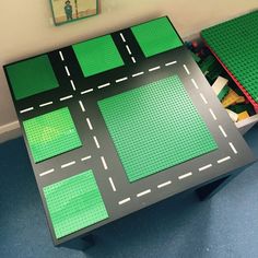 a table with green squares and white lines on it in the middle of a room