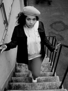 black and white photograph of woman walking up stairs