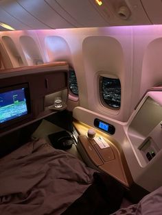 the inside of an airplane with a flat screen tv