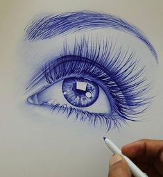 a drawing of an eye with blue eyeshade and long lashes, drawn on white paper