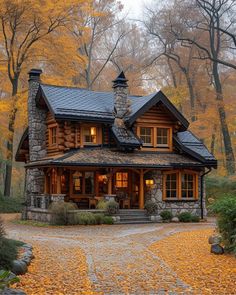 a small log cabin in the woods with autumn leaves on the ground and trees around it