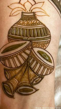 a woman's arm with a tattoo on it that has an image of a vase