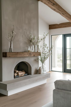 a living room filled with furniture and a fire place in front of a fireplace covered in candles